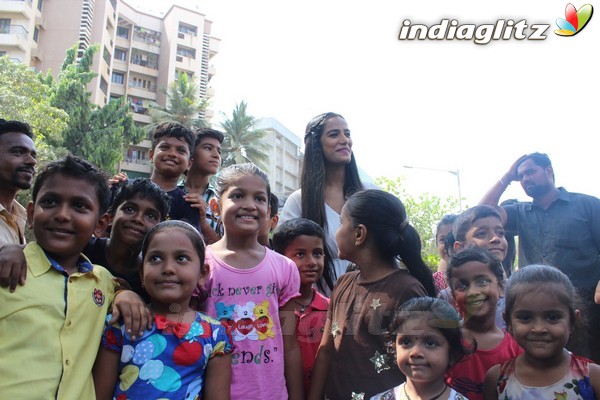 Poonam Pandey Distributes Raincoat To Needy Kids
