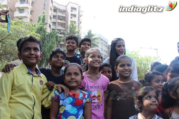 Poonam Pandey Distributes Raincoat To Needy Kids