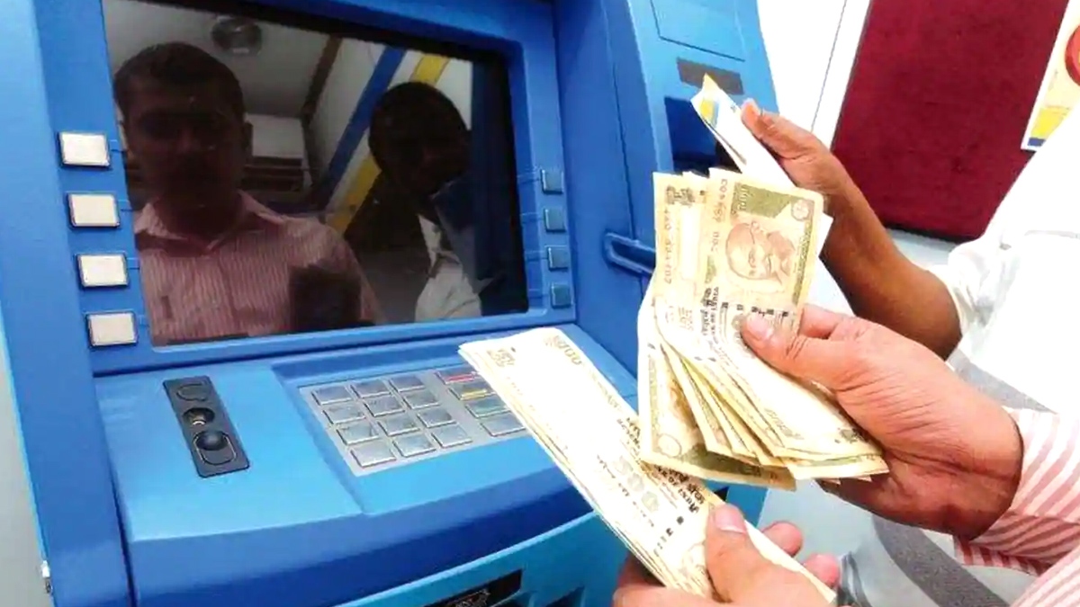 People gathered at an ATM centre after the machine dispensed Rs 2,500 ...