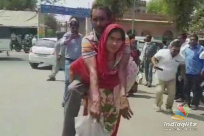 Women carries husband on her back to get disability certificate
