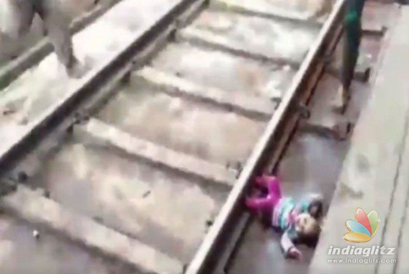 One year old baby escapes after falling in front of running train - Video