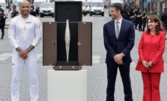 Olympics torch arrives in paris carried by louis vuitton luggage
