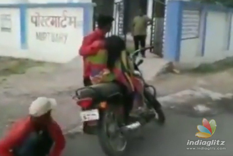 Son carries dead mother on bike for post mortem